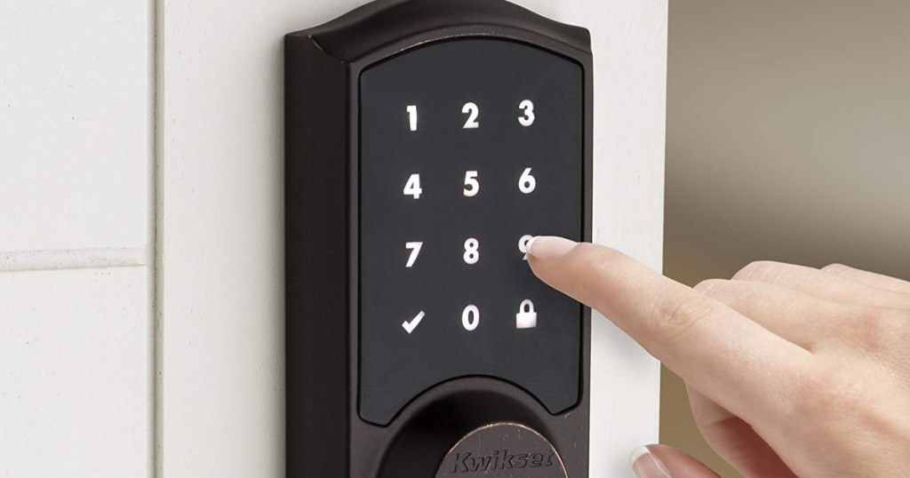 finger pressing numbers on electronic keypad