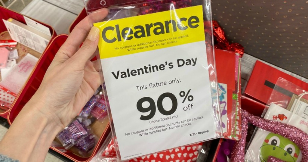 woman's hand holding Michaels Valentine's Day clearance sign