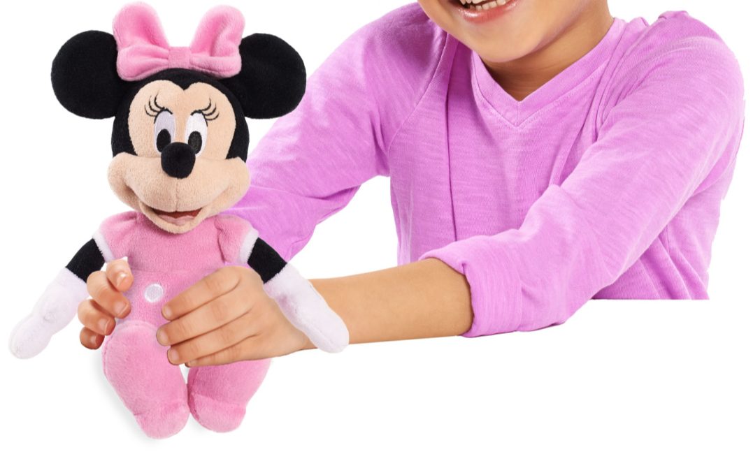 Girl holding Minnie Mouse plush