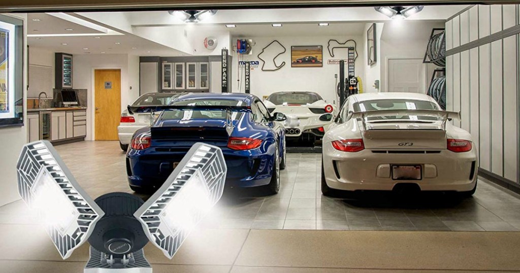 two sports cars in a garage with a light fixture superimposed on top