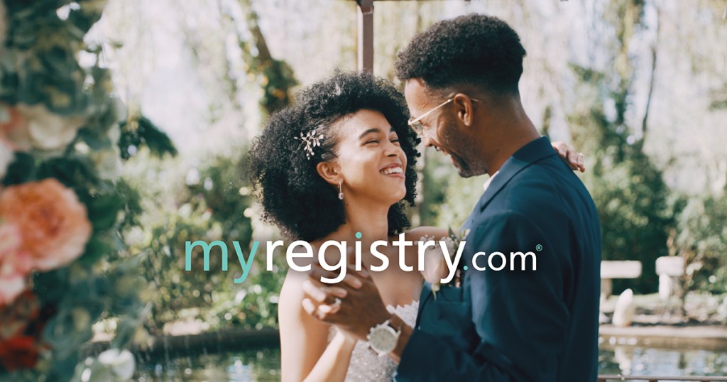 wedding couple dancing and smiling at each other with myregistry website in center