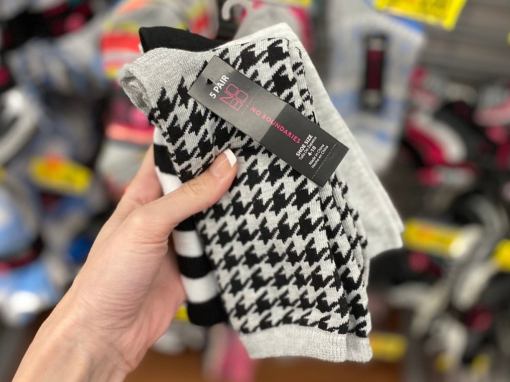 Woman's hand pair of socks in store