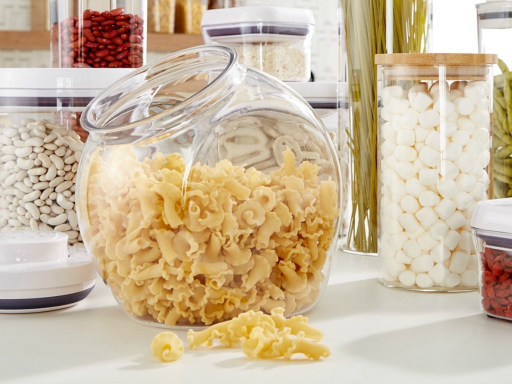 Large storage container with dry pasta inside near other coordinating storage containers
