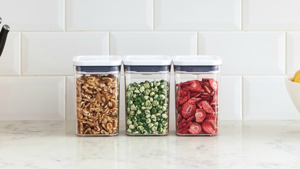 Three piece container set on counter with dried fruit, veggies and nuts