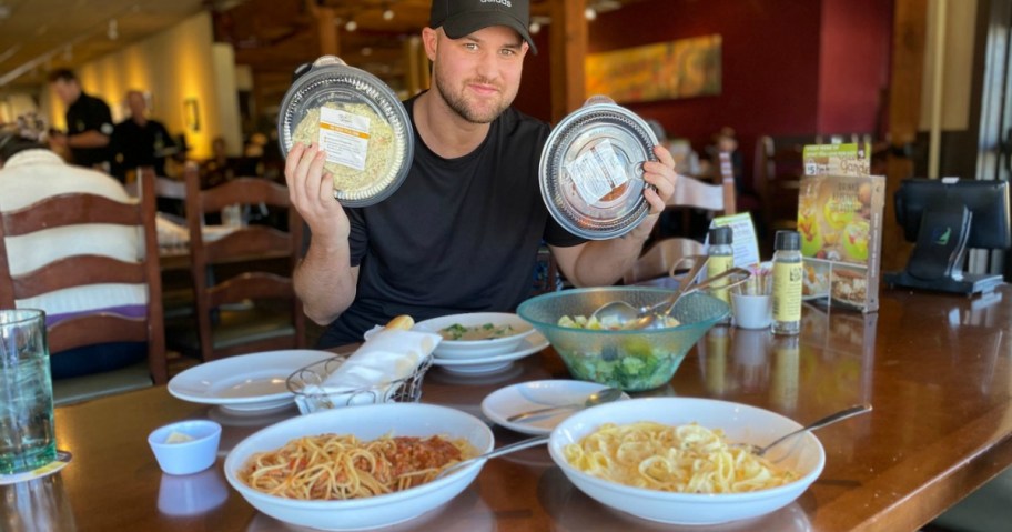 Man with to go trays at Olive Garden