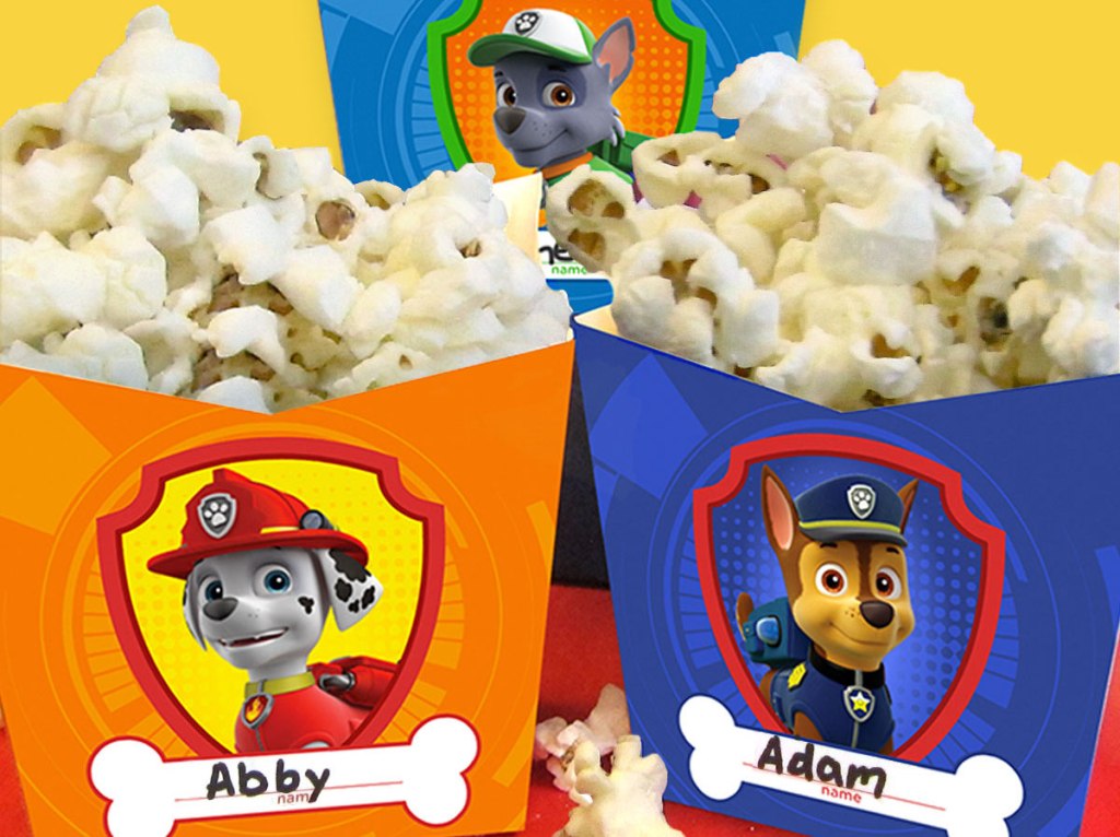 two Paw Patrol Popcorn Holders with popcorn in them