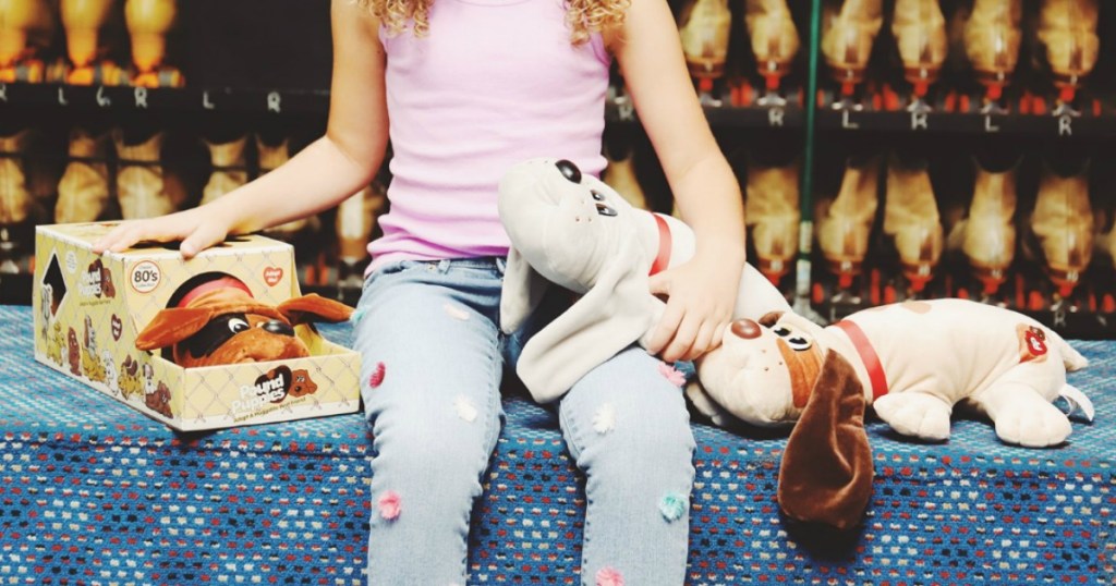Girl on rolling rink counter with vintage plush puppies