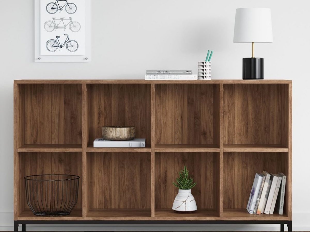 bookcase with lamp on it and books