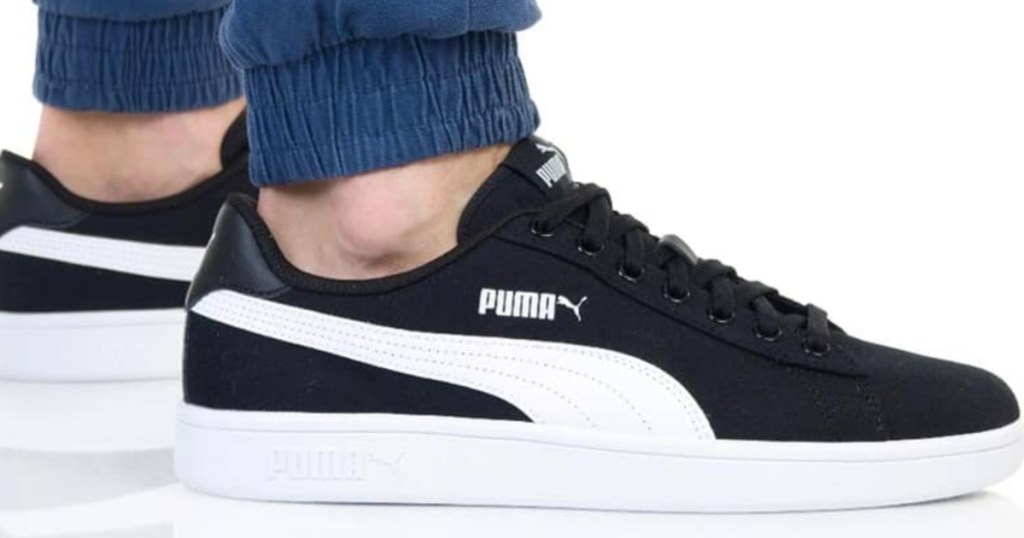 Man wearing Puma v2 Smash shoes