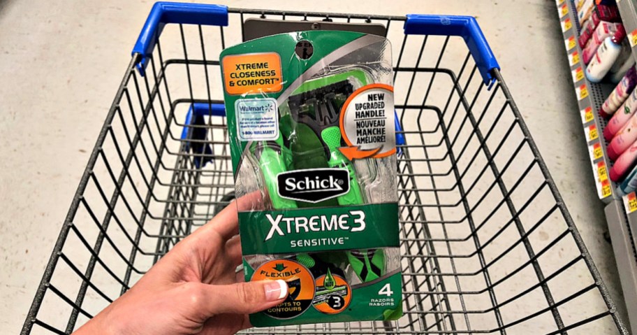Schick Xtreme 3 Sensitive Razors in hand in front of Walgreens shopping cart
