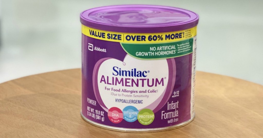 purple canister of infant formula sitting on a wooden ledge