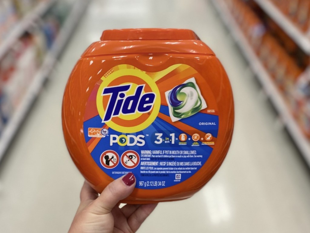 Woman's hand holding tide pods at Target 