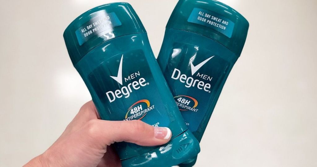 woman's hand holding two sticks of men's deodorant