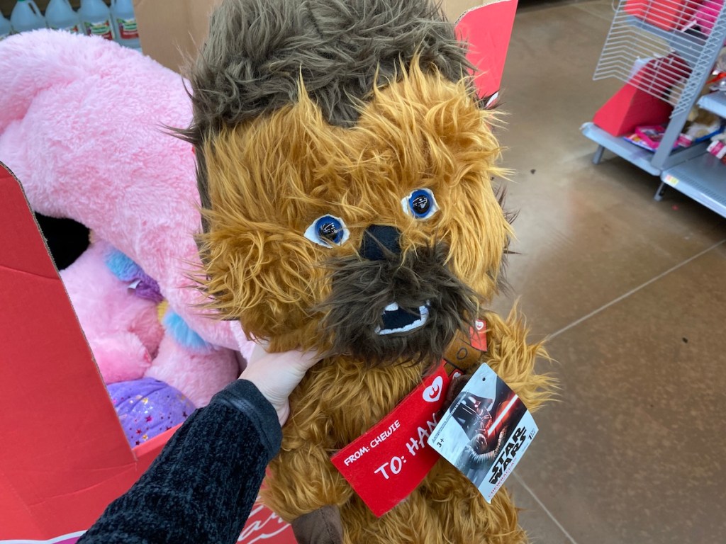hand holding a Chewbacca stuffed animal