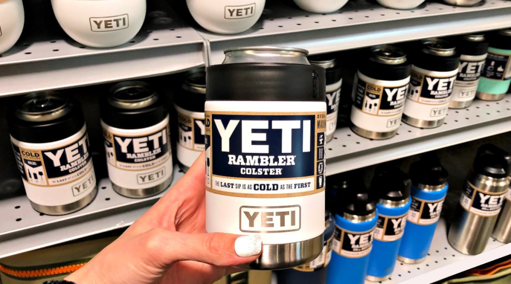 White Yeti Rambler Colster in woman's hand at store with shelves in background