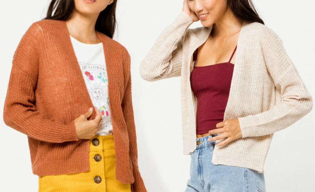 Two women wearing different colors of cardigans 