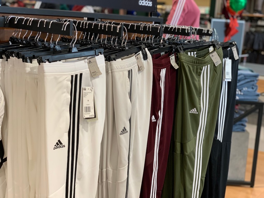 adidas women's pants hanging on a rack at a store