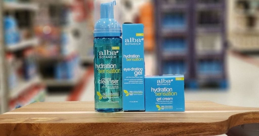 three skincare products sitting on a wooden table at the store