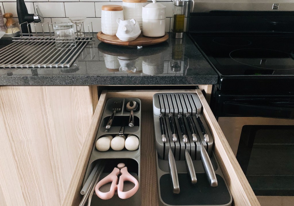 cutlery and knife drawer organizers in open kitchen drawer