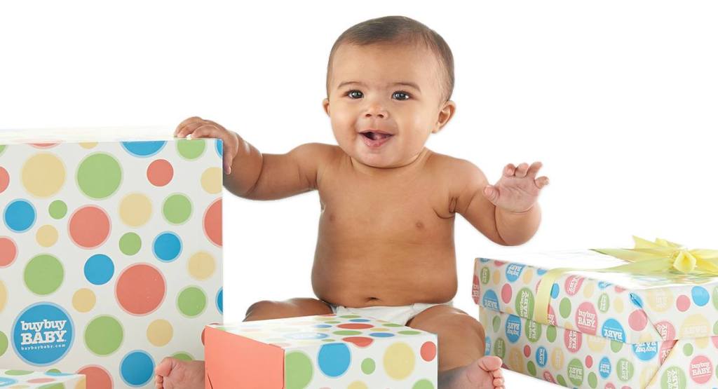 baby sitting by boxes with buybuyBaby wrapping paper