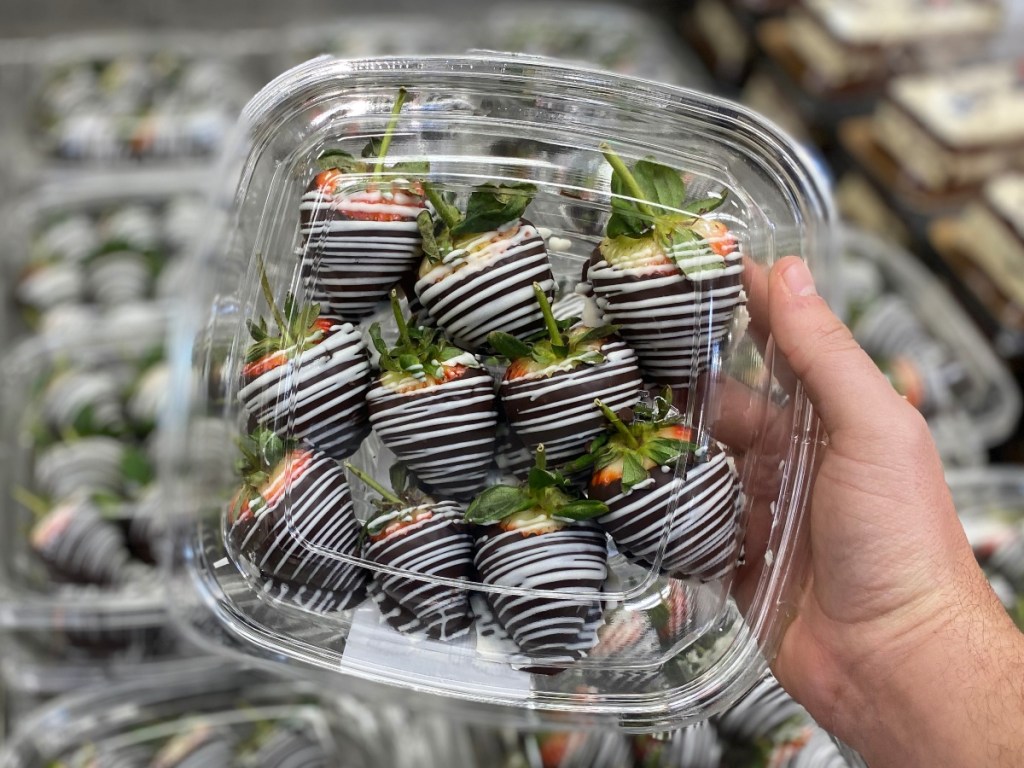hand holding Chocolate-covered strawberries at Costco