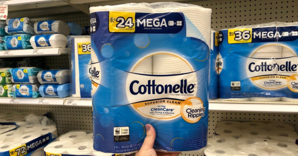hand holding package of Cottonelle toilet paper