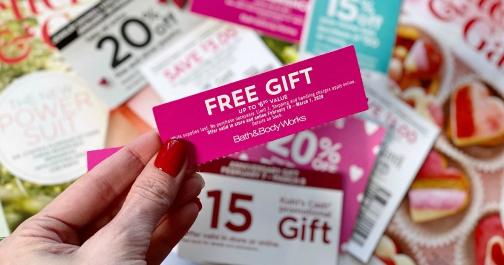 woman with red nails holding coupon for a free gift above various other coupons
