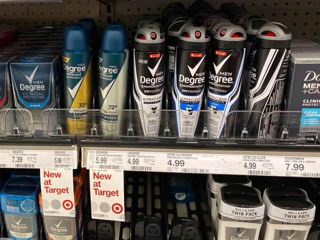 shelf of spray deodorant on display in a store 