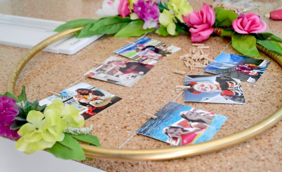 gold hula hoop with colorful florals and pictures in middle