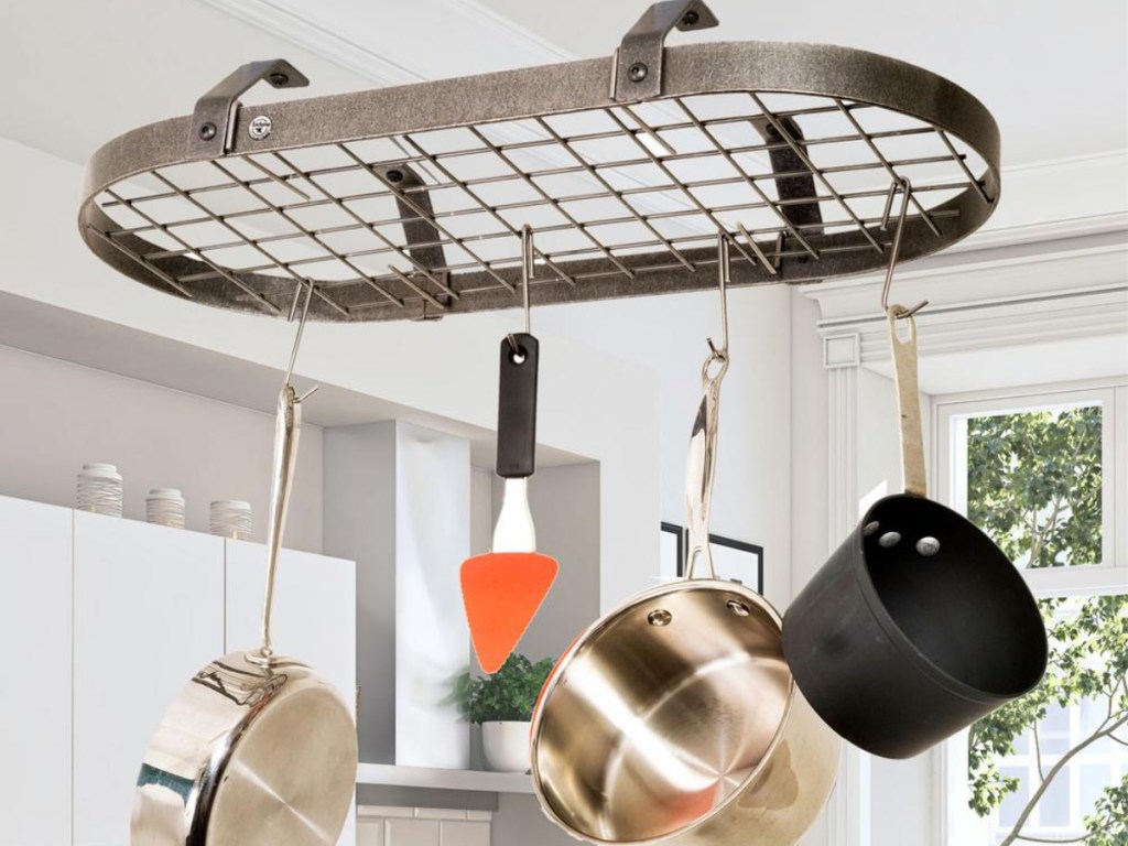 round pot rack holding pans pots and utensils in kitchen