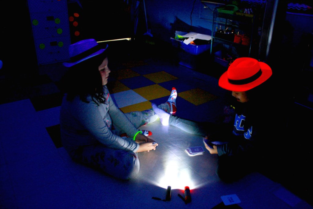 girls playing games in dark