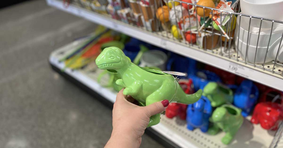 hand holding green dinosaur planter