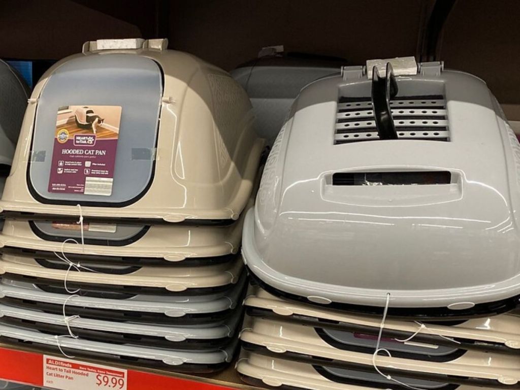 store shelf with two stacks of plastic cat litter boxes with domed lids