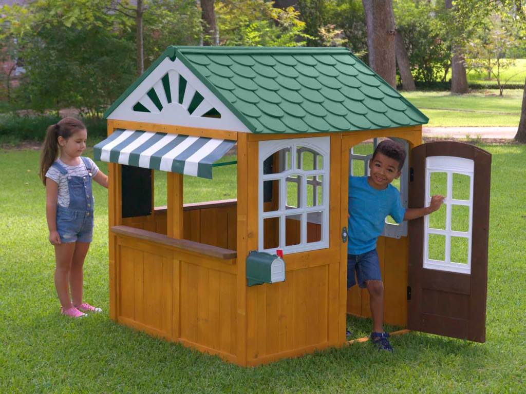 kids playing outside in a playhouse 