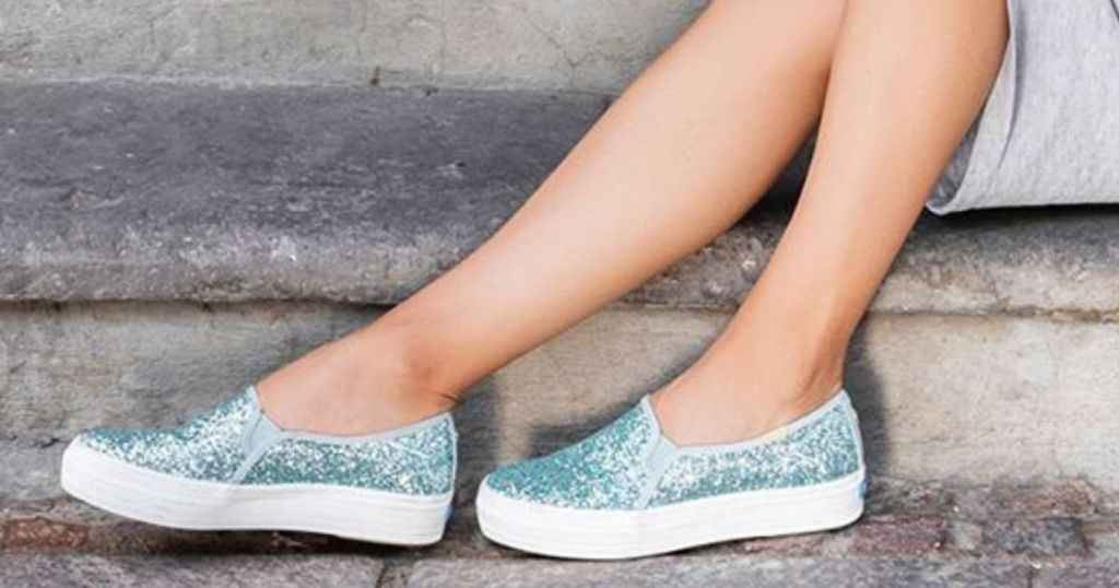 women's legs and feet wearing glittery canvas boat shoes