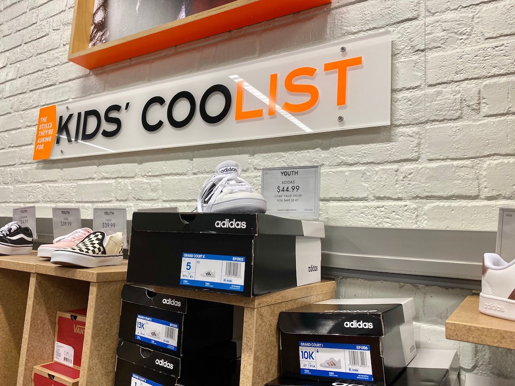 kids and youth shoe section at store with adidas and vans displayed