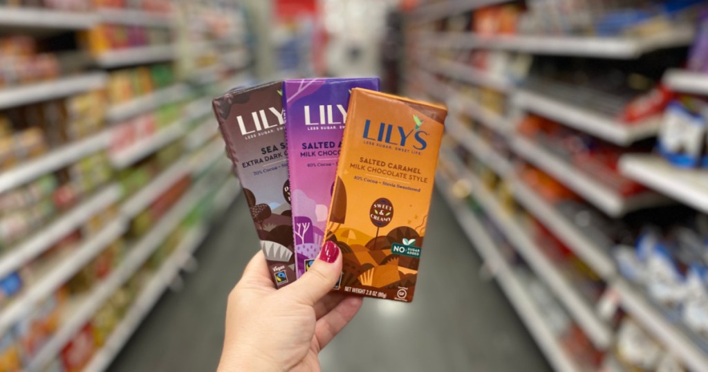 hand holding Lily's chocolate bar in store with blurred background