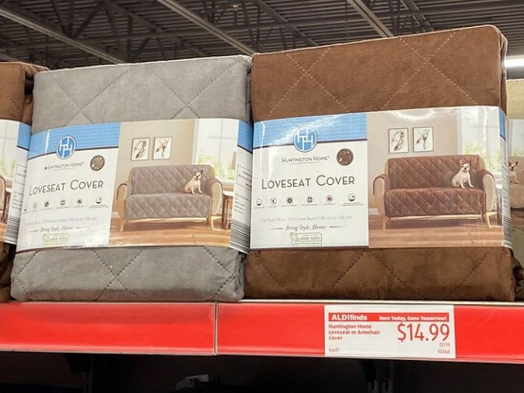 store shelf with two brand new in package love seat covers on it 