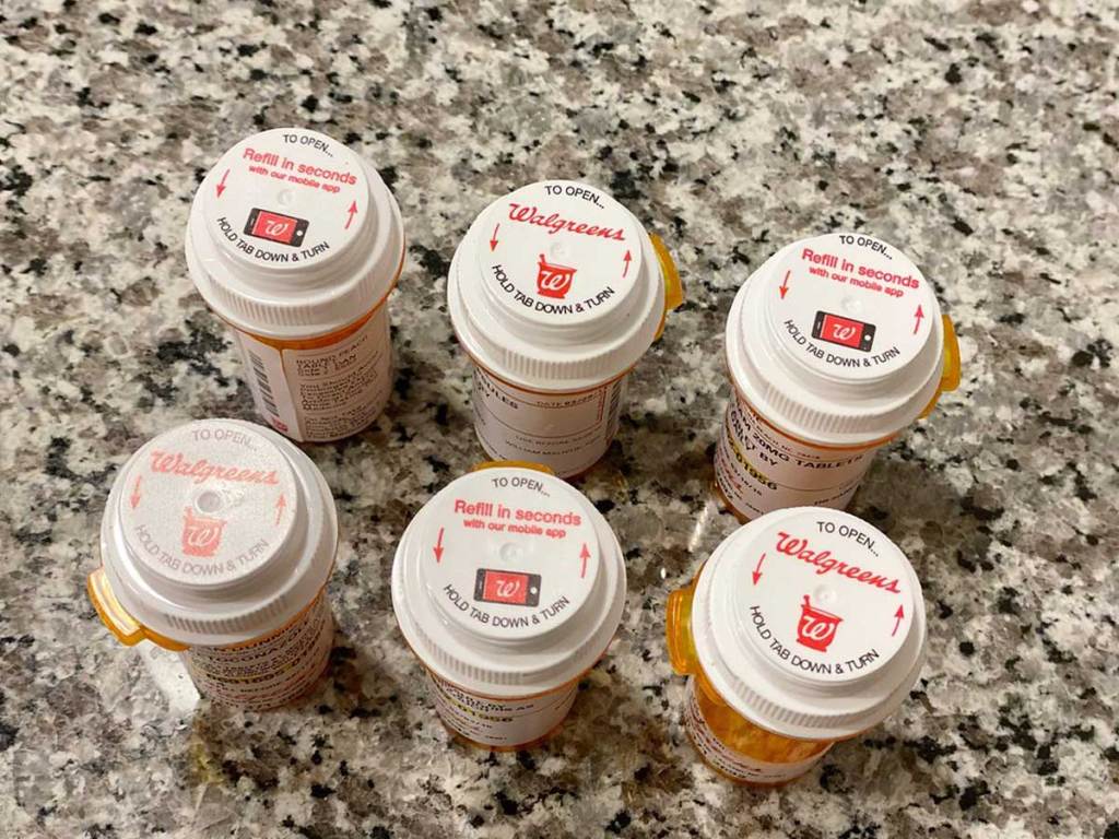 six prescription bottles on a counter