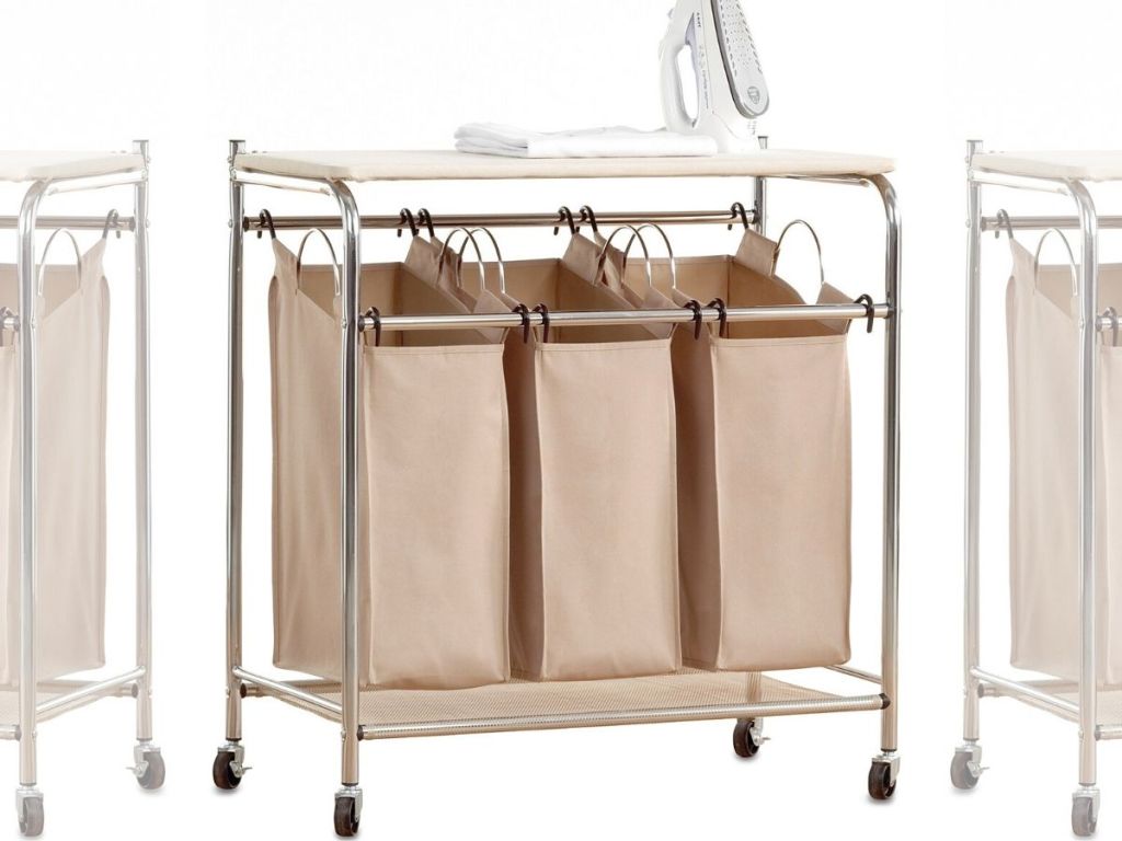 triple laundry sorter station with cloth hanging bags, metal frame and ironing board top with iron set on it