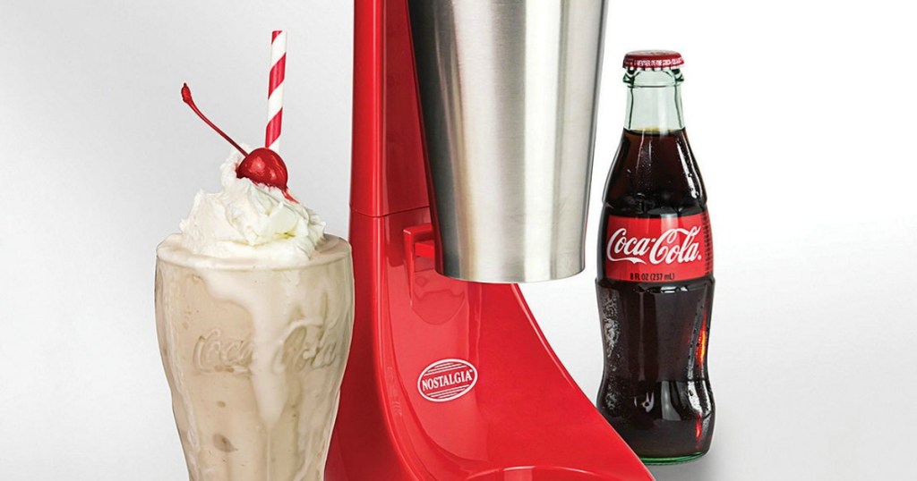 coke bottle and cup with ice cream in it next to red machine
