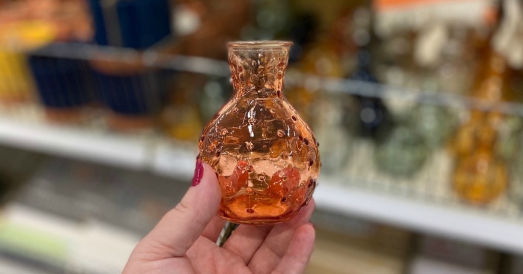 hand holding peach glass vase in Target store
