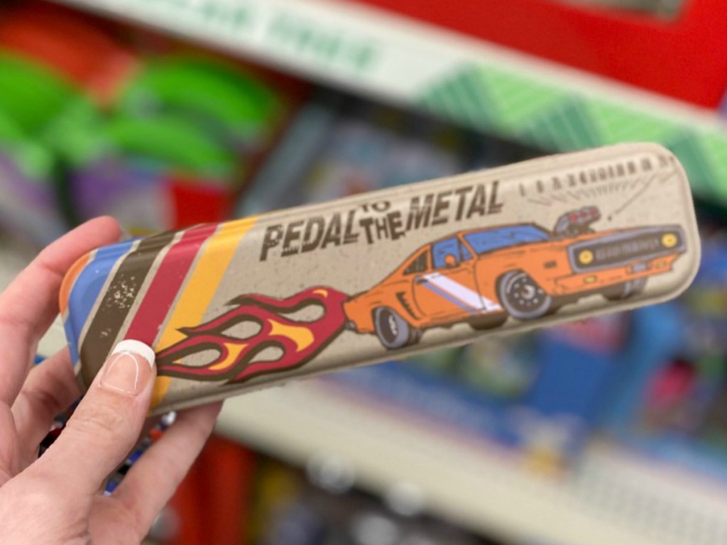 hand holding pencil box with race car on it