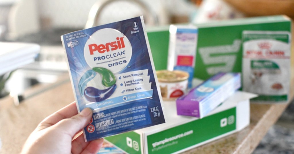 hand holding persil proclean discs packet