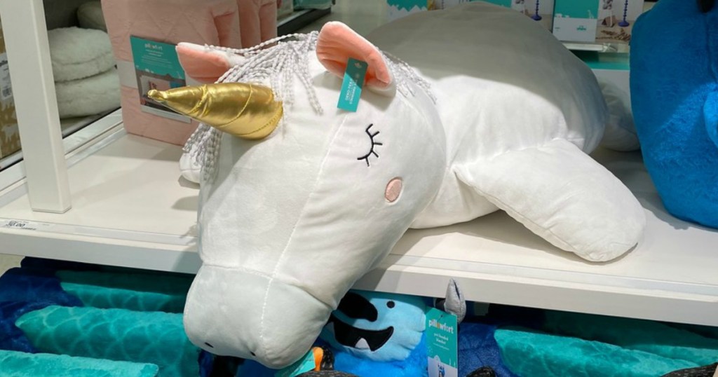 large unicorn pillow on store shelf