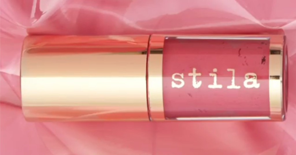 pink Stila Shine Fever Lip Vinyl with pink fabric background