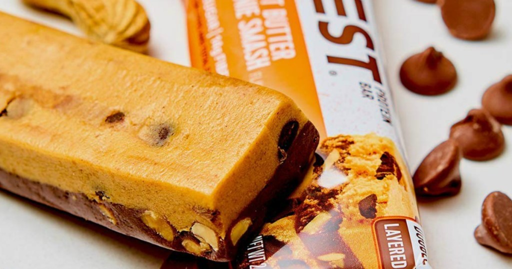 protein bar by package and chocolate chips on counter