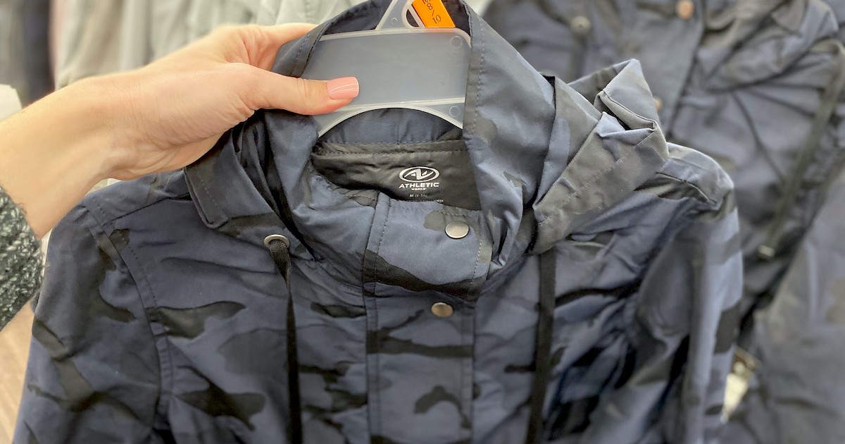 hand holding blue and black camo ran jacket on clear hanger