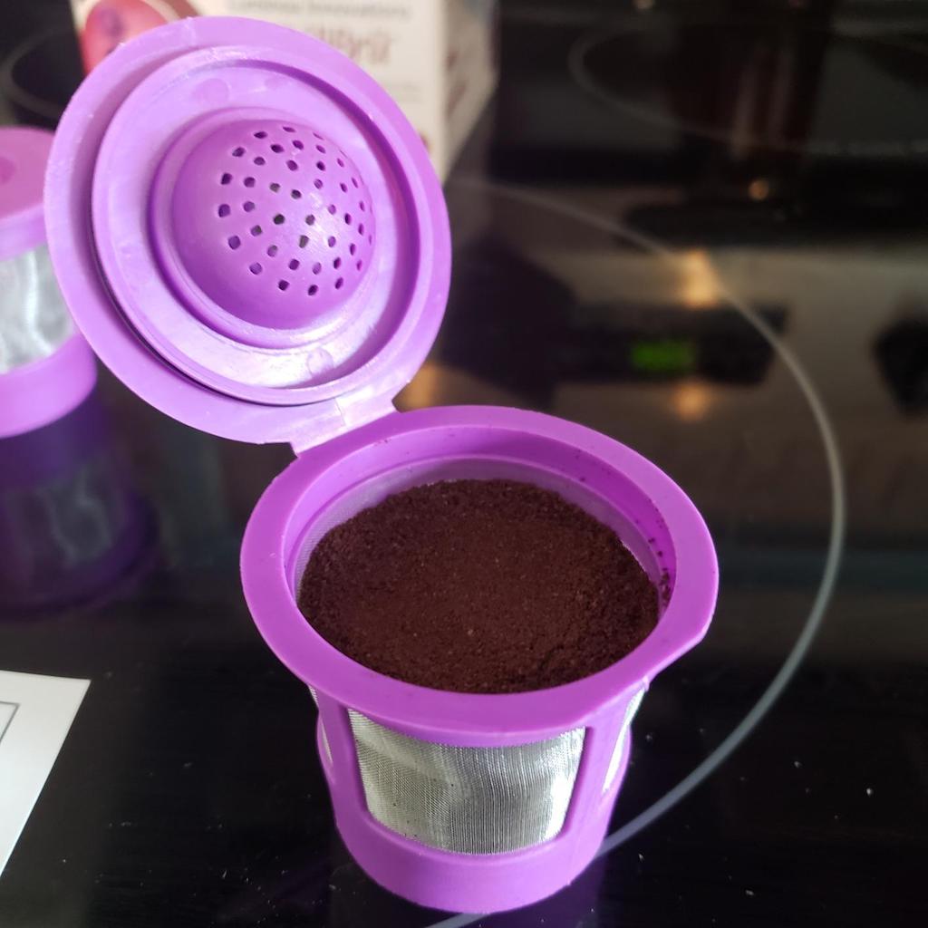 resuable k-cup pod with ground coffee inside 
