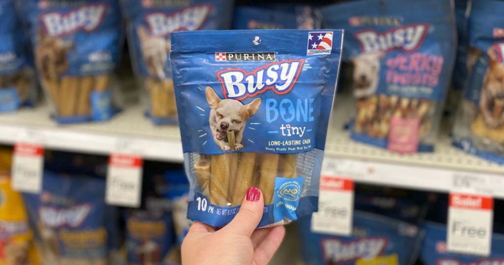 hand holding dog treats in a store
